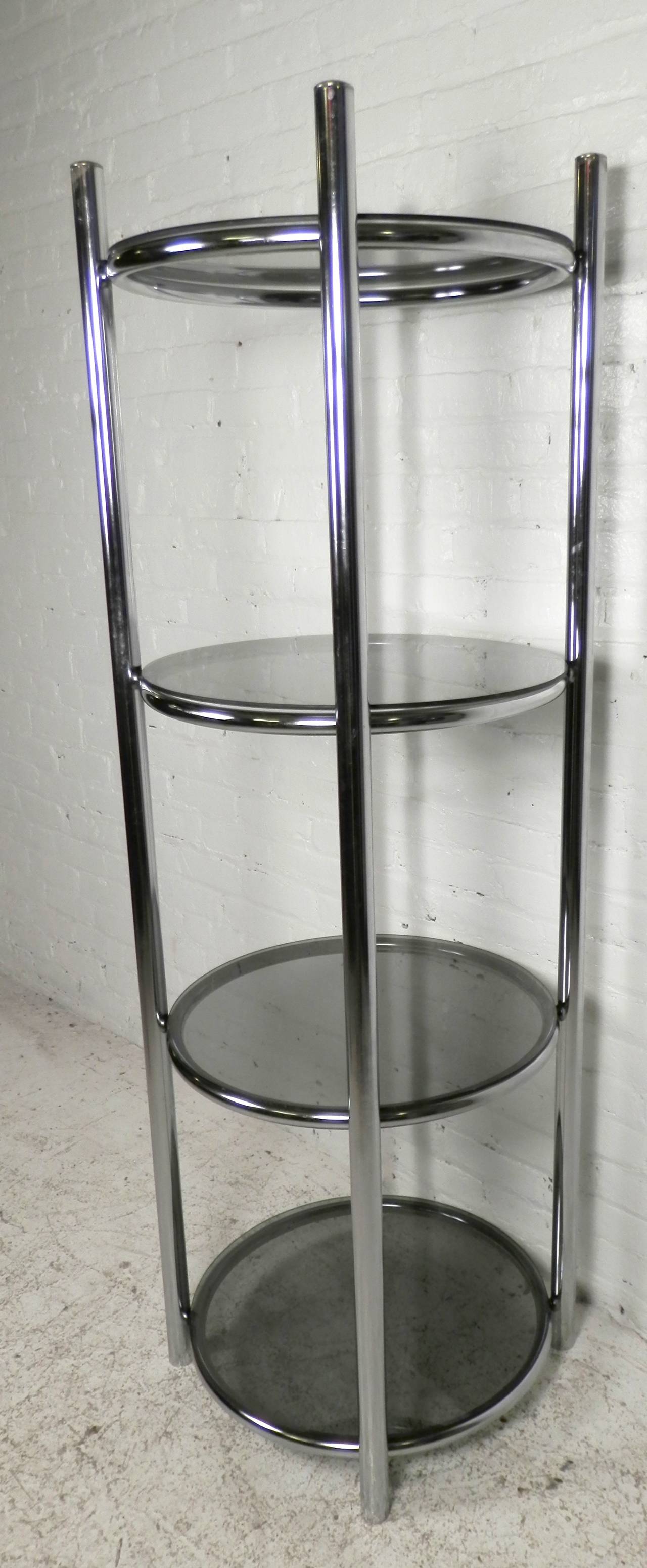 Mid-century modern style shelving unit with four round shelves. Smoked tinted glass compliments the chrome frame nicely. This is a great display choice for smaller rooms.

(Please confirm item location - NY or NJ - with dealer)
