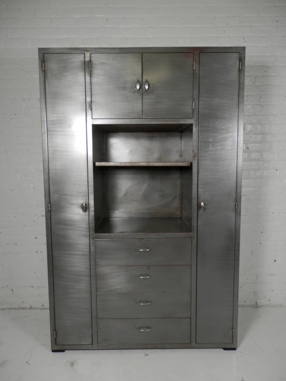 Fantastic wall unit made of stripped metal. Four drawers, two lockers and a top cabinet, plus a removable middle shelf. Quite a statement piece!