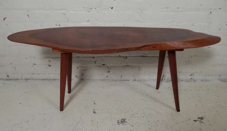 Unique table with figural live edges and delicate tapered legs. Gorgeous grain on top with light brown and red tones.
Stamped with label.

(Please confirm item location - NY or NJ - with dealer)