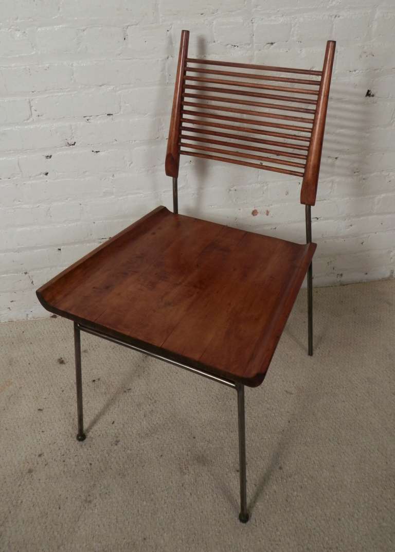 This Paul McCobb side chair is a great example of mid-century modern design becoming more of an artistic piece while still retaining it's function. Sturdy yet simple metal frame with sculpted wood seat and fine ladder back.

(Please confirm item