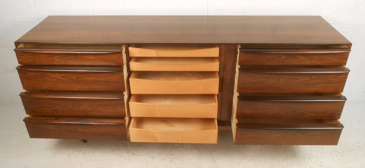 Beautifully detailed eight drawer rosewood credenza by Falster. Center tambour door reveals five additional trays for added storage. Finished on all sides. Please confirm item location (NY or NJ) with dealer.