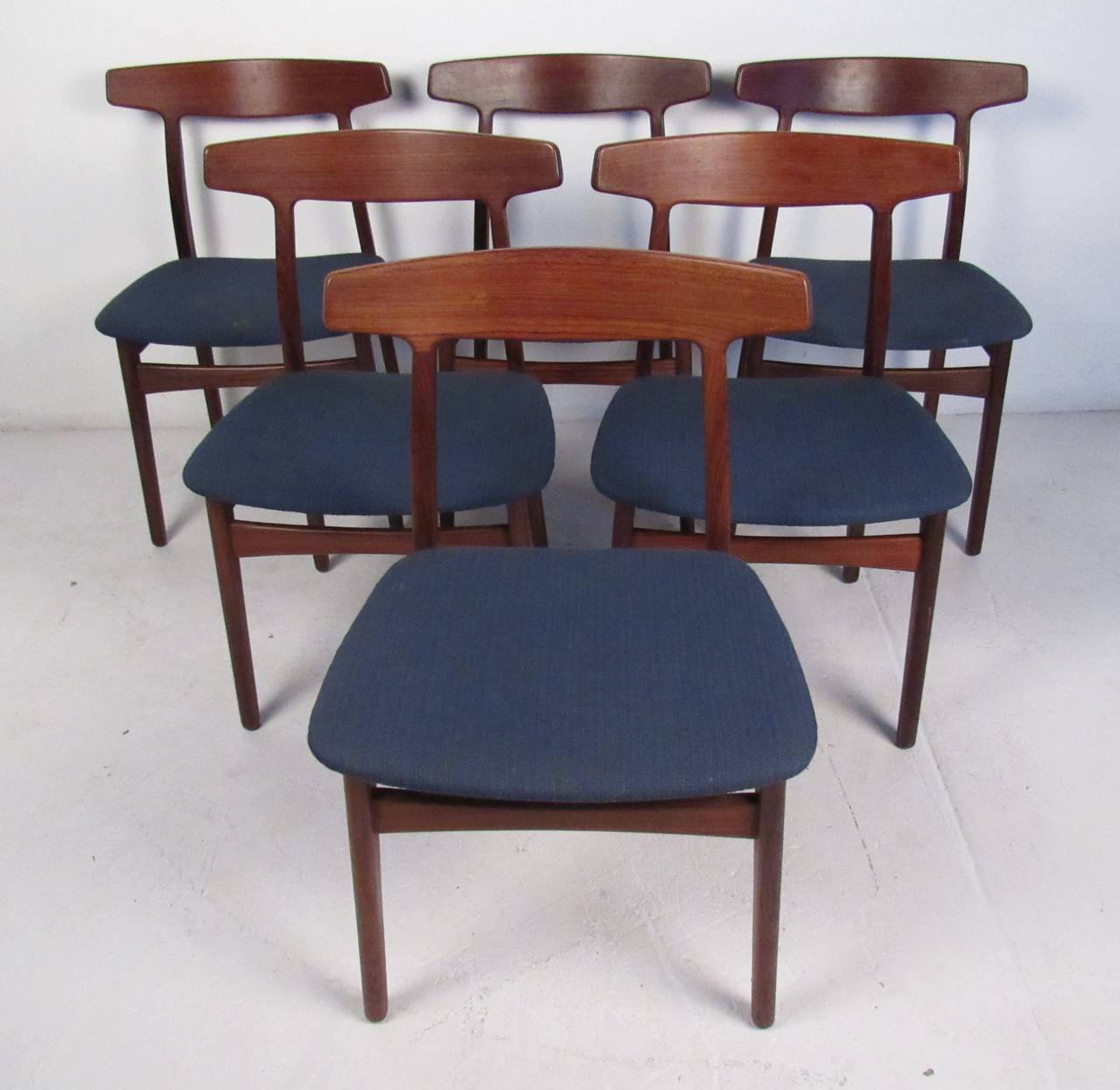 Rare set of six rosewood chairs by Henning Kjaernulf, Denmark, 1955. Beautifully detailed solid rosewood frames with gently curved laminated backrests. Teak draw-leaf dining table expands from 57