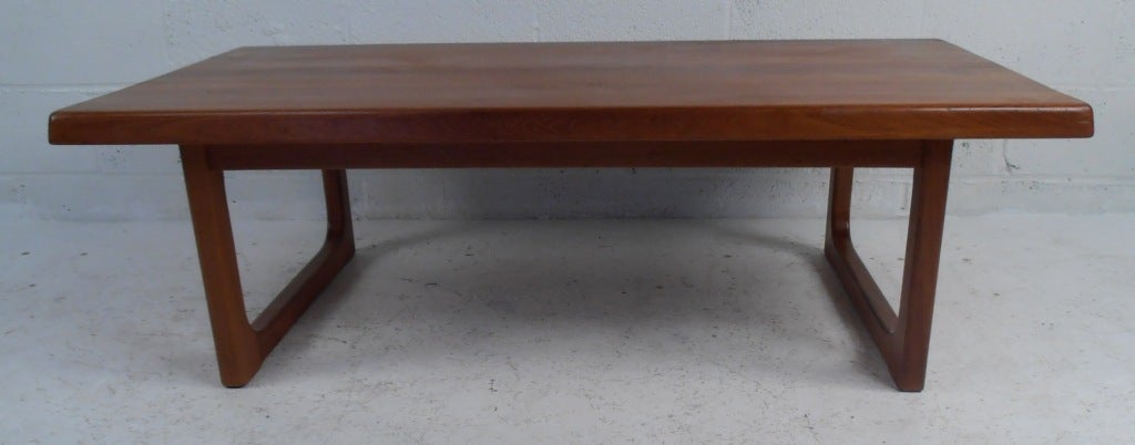 Vintage solid teak coffee table by Niels Bach. The unique sled legs, smooth edges, and elegant wood grain shows quality craftsmanship. Please confirm item location (NY or NJ).