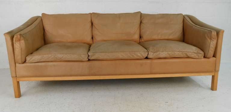Original leather three seater sofa by Stouby. Age related wear and fading. Please confirm item location (NY or NJ) with dealer.