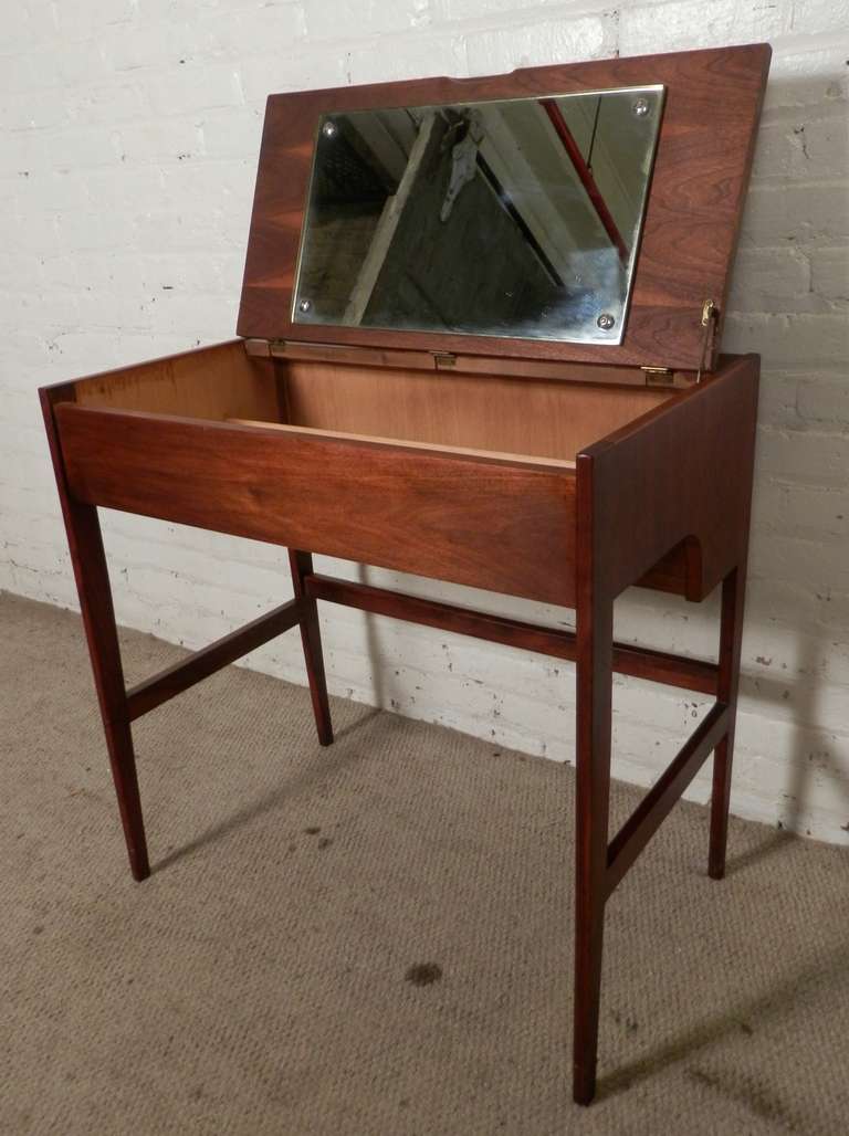 Unique and compact 1960's walnut dressing table, featuring fold away mirror and ample storage space. Please confirm item location (NY or NJ).