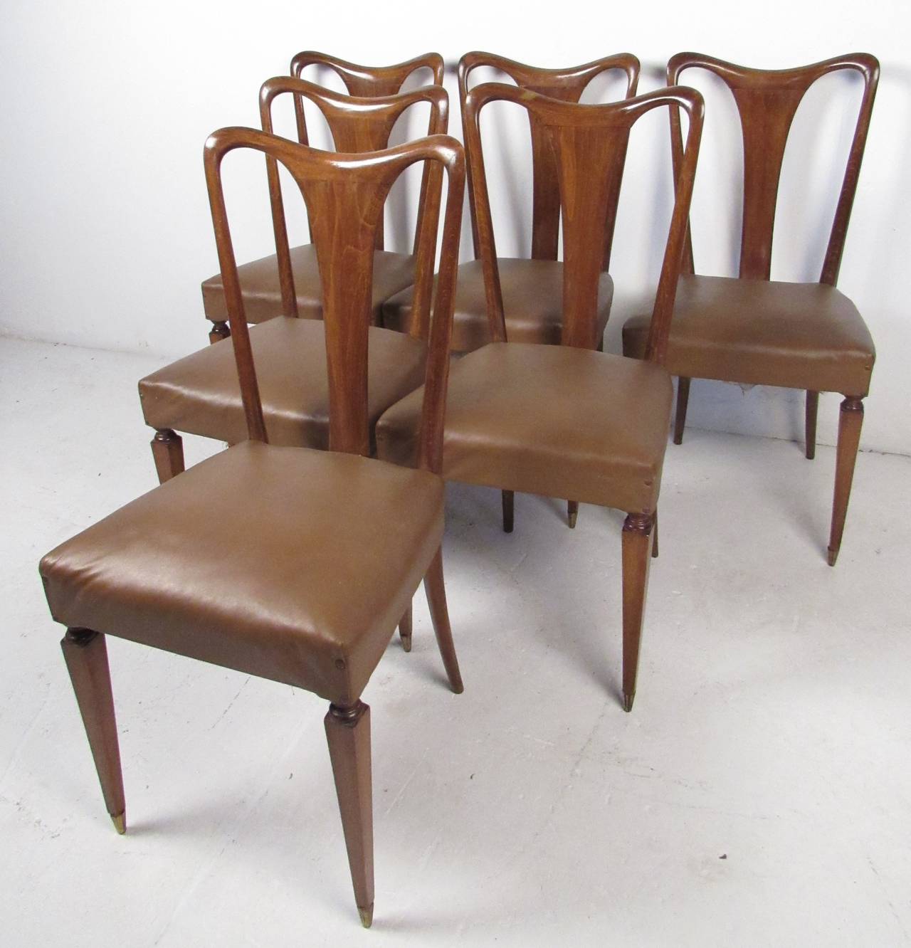 Set of six elegant high back dining chairs with vinyl seats and pencil point legs. Please confirm item location (NY or NJ) with dealer.