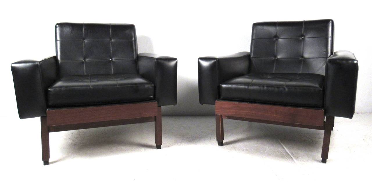 Great pair of comfortable tufted black vinyl lounge chairs with walnut bases. Unique mid-century Scandinavian modern style adds impressive seating to any interior. Please confirm item location (NY or NJ) with dealer.