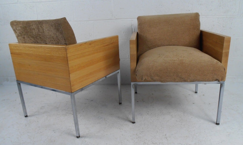 Vintage modern mix of solid oak and chrome frames make these butcher block style club chairs a stylish addition to any interior. Unique blend of Mid-Century Modern style and time less comfort makes this matching pair an impressive addition to any