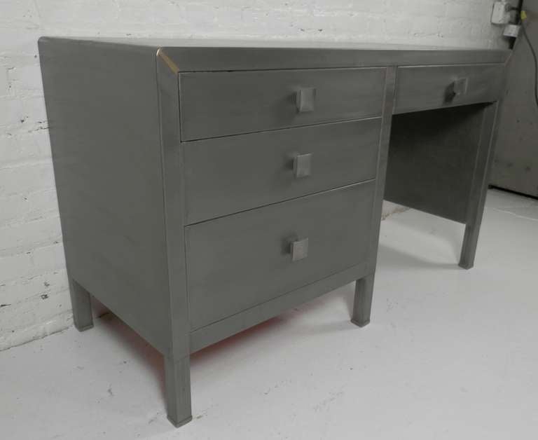 Vintage metal desk by Simmons. Classic Norman Bel Geddes design with original large square hardware, rounded edges, and industrial strength materials. Newly restored to bare metal for a handsome modern look.

(Please confirm item location - NY or