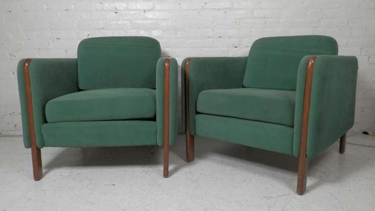 Pair of vintage modern lounge chairs by Milo Baughman for Thayer Coggin. Unusual design with wood incorporated into the vintage upholstered cushioned arms. Solid modern shape with thick padding all around for maximum comfort, this pair of Thayer