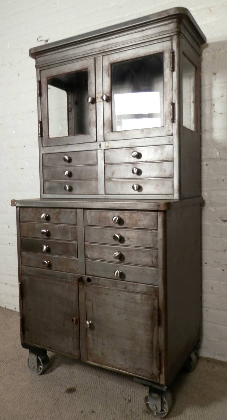 Industrial metal factory cabinet set on large casters, newly restored in a rough 