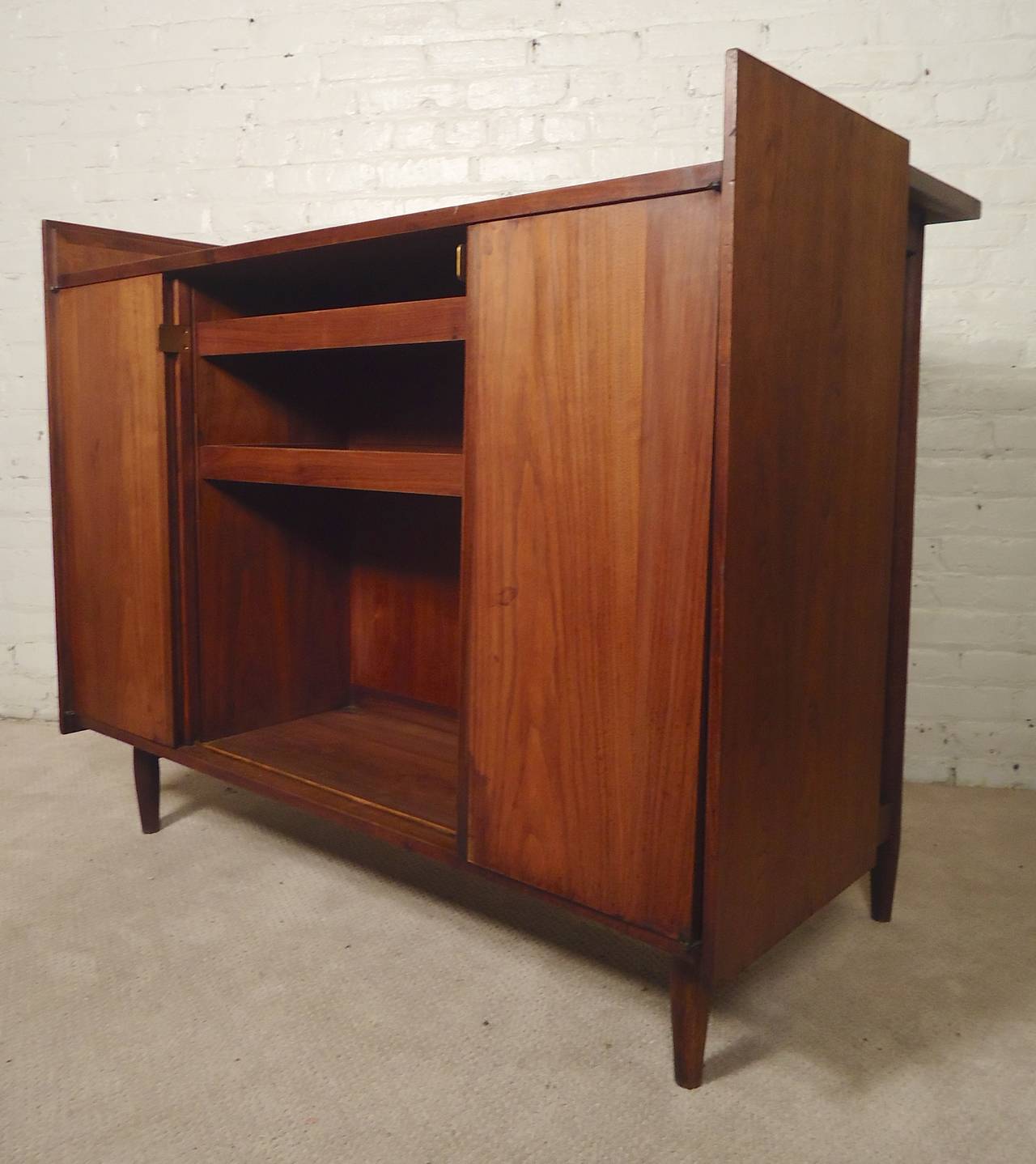 Excellent dry bar with caning detail on the front and back. Ample storage with side doors, middle sliding doors, black work top, sculpted bar surface. Attractive walnut grain throughout. Lots of function!

(Please confirm item location - NY or NJ