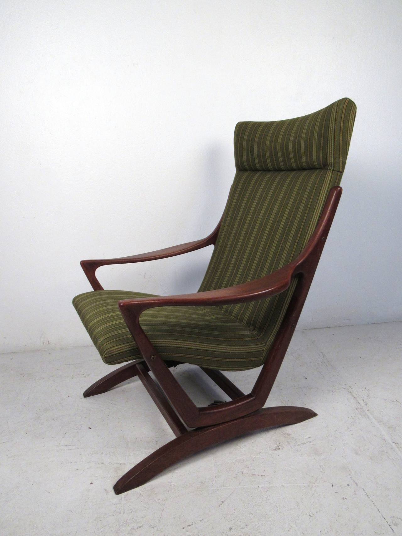 This mid-century modern rocking chair in the style of Adrian Pearsall features a solid walnut construction and vintage upholstery which offers a modern flare and comfortable seating for any home or office space.

Please confirm item location (NY or