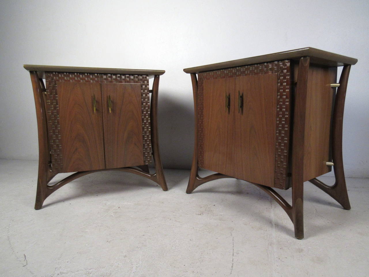 This pair of mid-century modern Piet Hein cabinets feature a unique sculptural profile accented by lattice woodwork and brass pulls, 
for use as nightstands or end tables.  Please confirm item location (NY or NJ) with dealer.