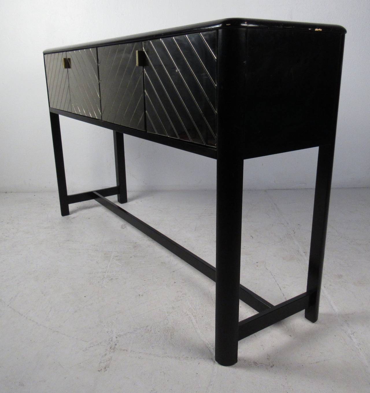 Black lacquer console table with mirrored doors opening to two storage compartments. Please confirm item location (NY or NJ) with dealer.
