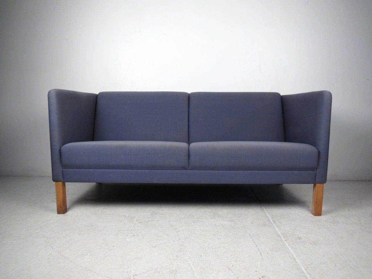 This mid-century modern Danish sofa features clean lines and unique tapered legs. Scandinavian modern style adds a retro flare to any home or office space. Perfect two-seat sofa for home seating area or office waiting room.
Please confirm item