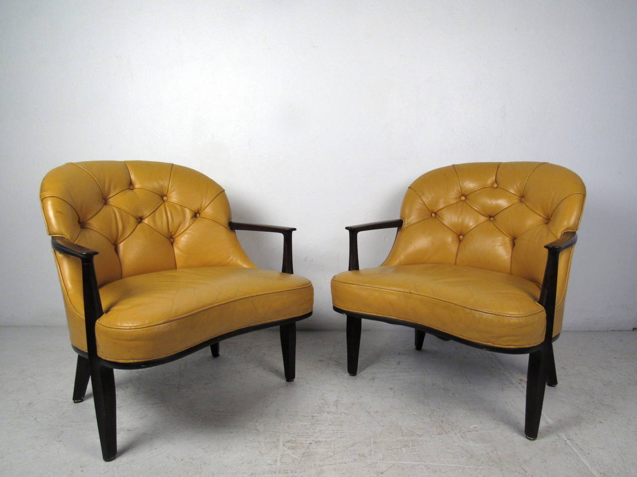 This pair of lounge chairs by Dunbar feature original tufted yellow upholstery and unique carved wood frames which offer a modern flare and comfortable seating to any home or office space.

Please confirm item location (NY or NJ) with dealer.