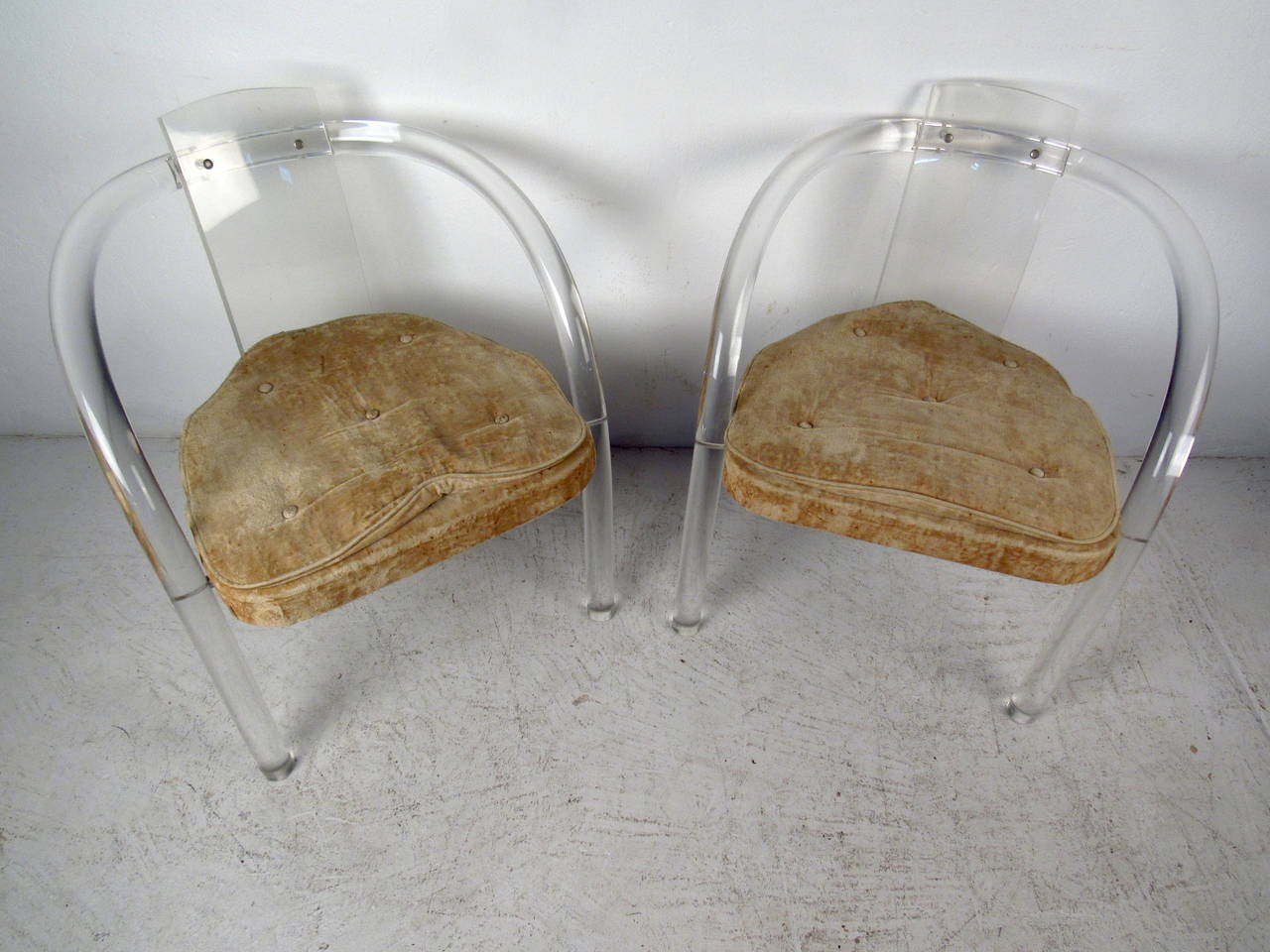 This pair of chairs features a solid lucite construction and tufted upholstery seat which offer a sleek, modern flare to any home or office space.

Please confirm item location (NY or NJ) with dealer.