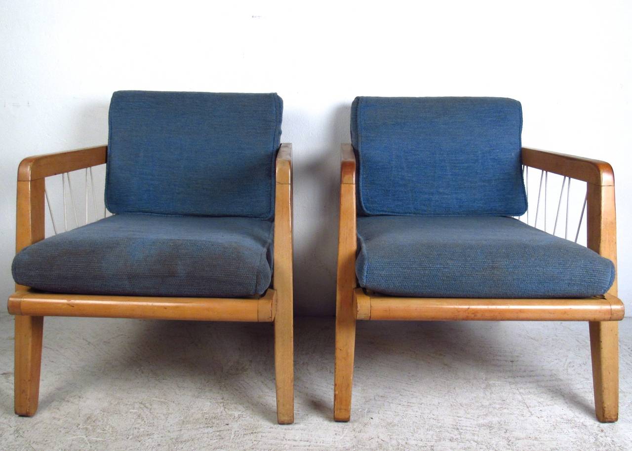 This unique pair of Edward Wormley club chairs features wonderful rope strung frames in a comfortable low profile design. Matching Drexel set (c. 1940s) shows some age appropriate wear, but makes a stylish and comfortable addition to any interior.