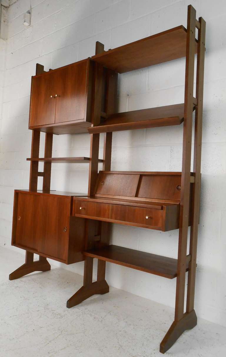 Mid-century walnut free-standing wall unit with writing desk and multiple storage options. Please confirm item location (NY or NJ) with dealer.