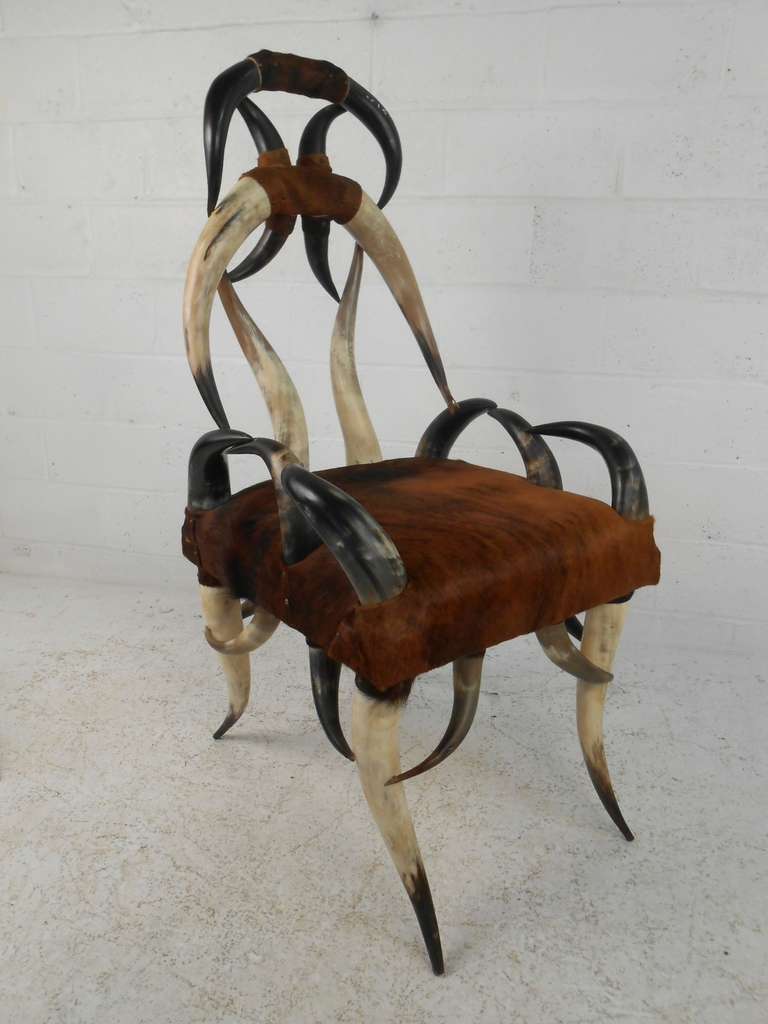 Unique rustic Texas longhorn frame chair with cowhide upholstered seat. This comfortable and sturdy lounge chair is sure to make a lasting impression in any seating arrangement. Please confirm item location (NY or NJ) with dealer.