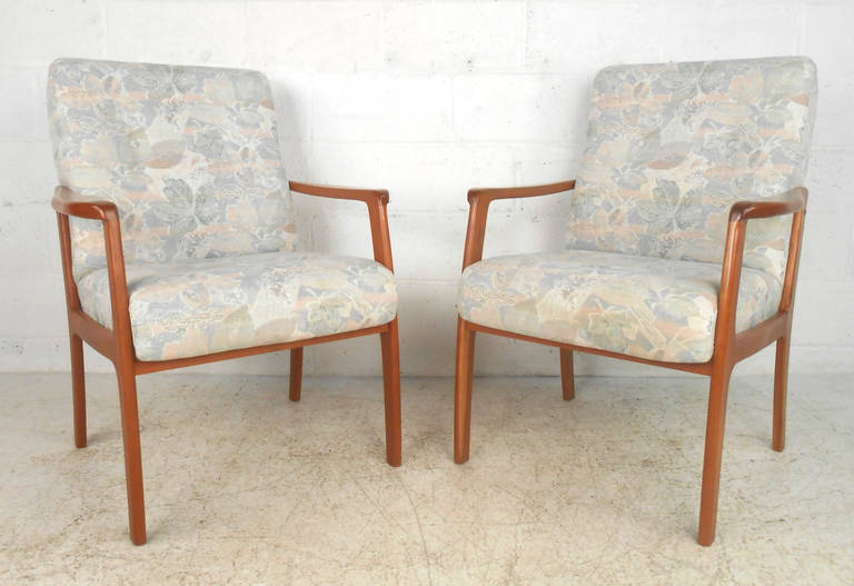This Canadian made pair of matching upholstered lounge chairs features sturdy construction and stylish body design. With slim teak frames in the traditional midcentury style this pair makes a great seating addition to home or office. Please confirm