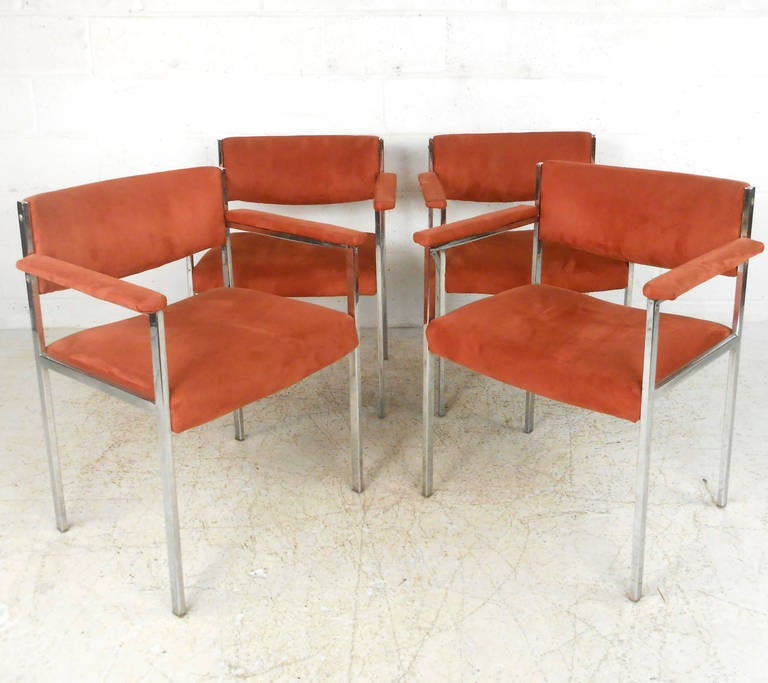 This beautiful set of four vintage suede armchairs makes a stylish and comfortable addition to any home or business. Perfect for conference rooms, waiting rooms, or dining situations this foursome offers padded armrests and sleek chrome frames.