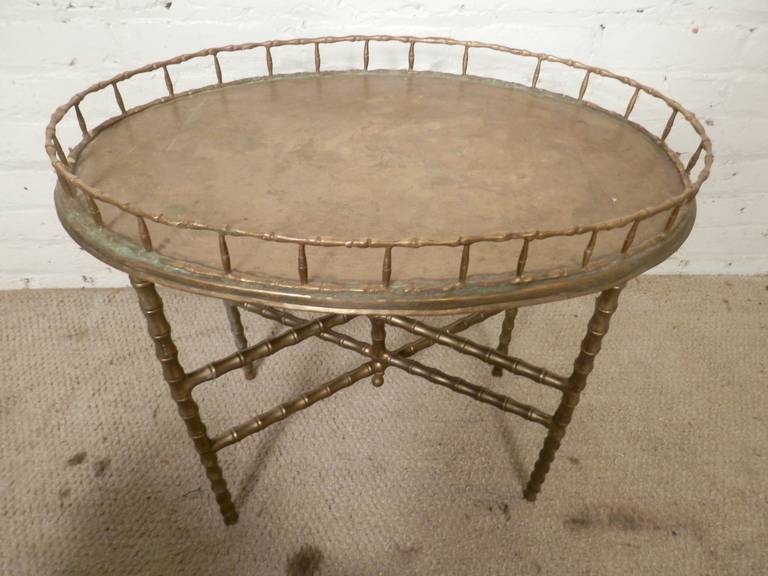 Vintage limited edition brass hand crafted collapsible serving table from India. Includes Hollywood regency style Bamboo brass legs with removable serving tray. Attractive patina coloring on brass. 

(Please confirm item location - NY or NJ - with