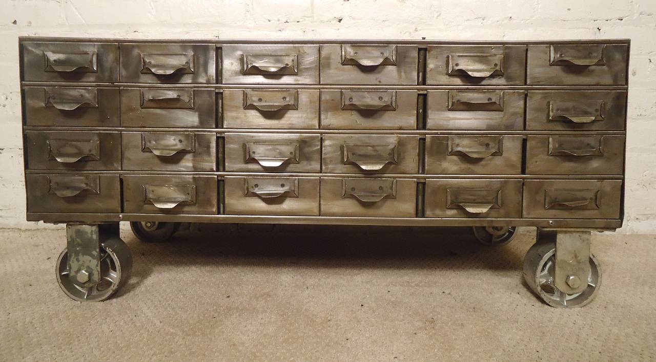 Vintage metal filing cabinet set on large industrial casters. All restored in a handsome industrial finish. Makes a cool vintage metal table.
Drawers measure: 5w 16d 2h

(Please confirm item location - NY or NJ - with dealer)