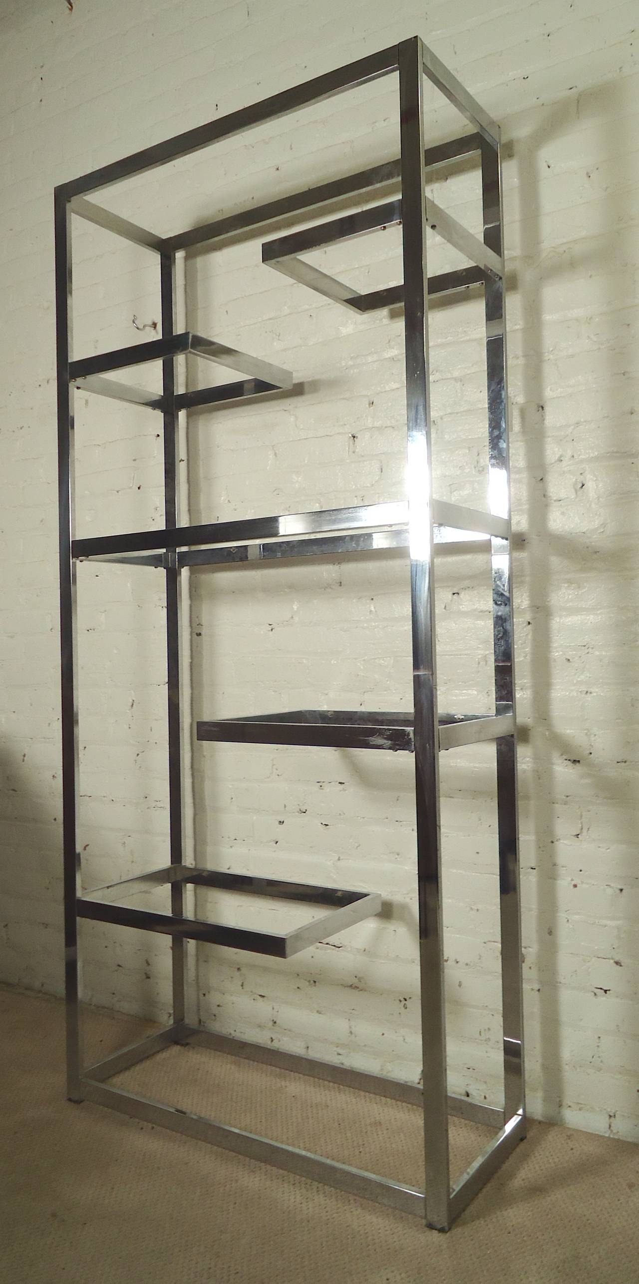 Milo Baughman shelving unit in polished chrome with step level design. Attractive storage unit for home or office.

(Please confirm item location - NY or NJ - with dealer).