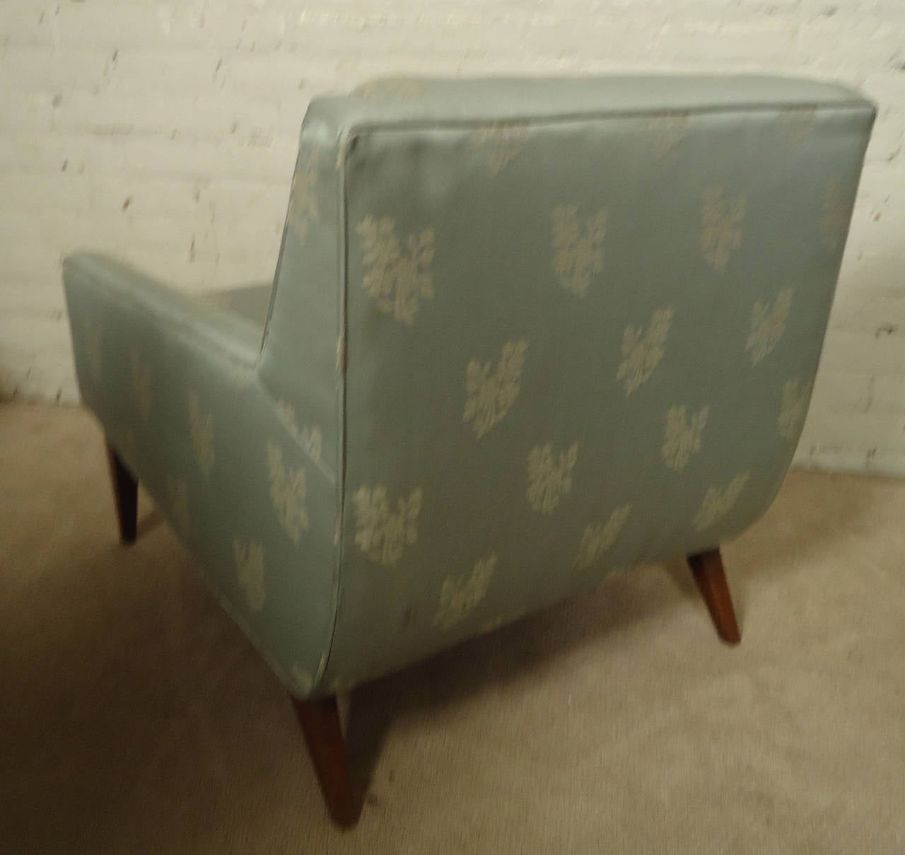Vintage-modern lounge chair, features floral upholstery with walnut base, includes matching ottoman.

Ottoman dimensions: 24 W x 22 D x 15 H
(Please confirm item location, NY or NJ with dealer).
