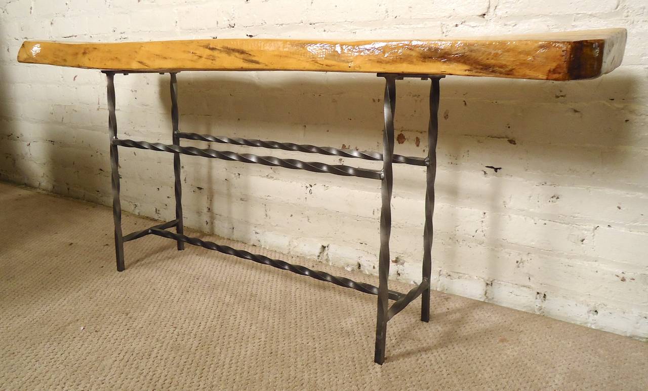 Vintage bench made of a slab of blonde wood with attractive live edge. Set on twisted iron frame.

(Please confirm item location - NY or NJ - with dealer)