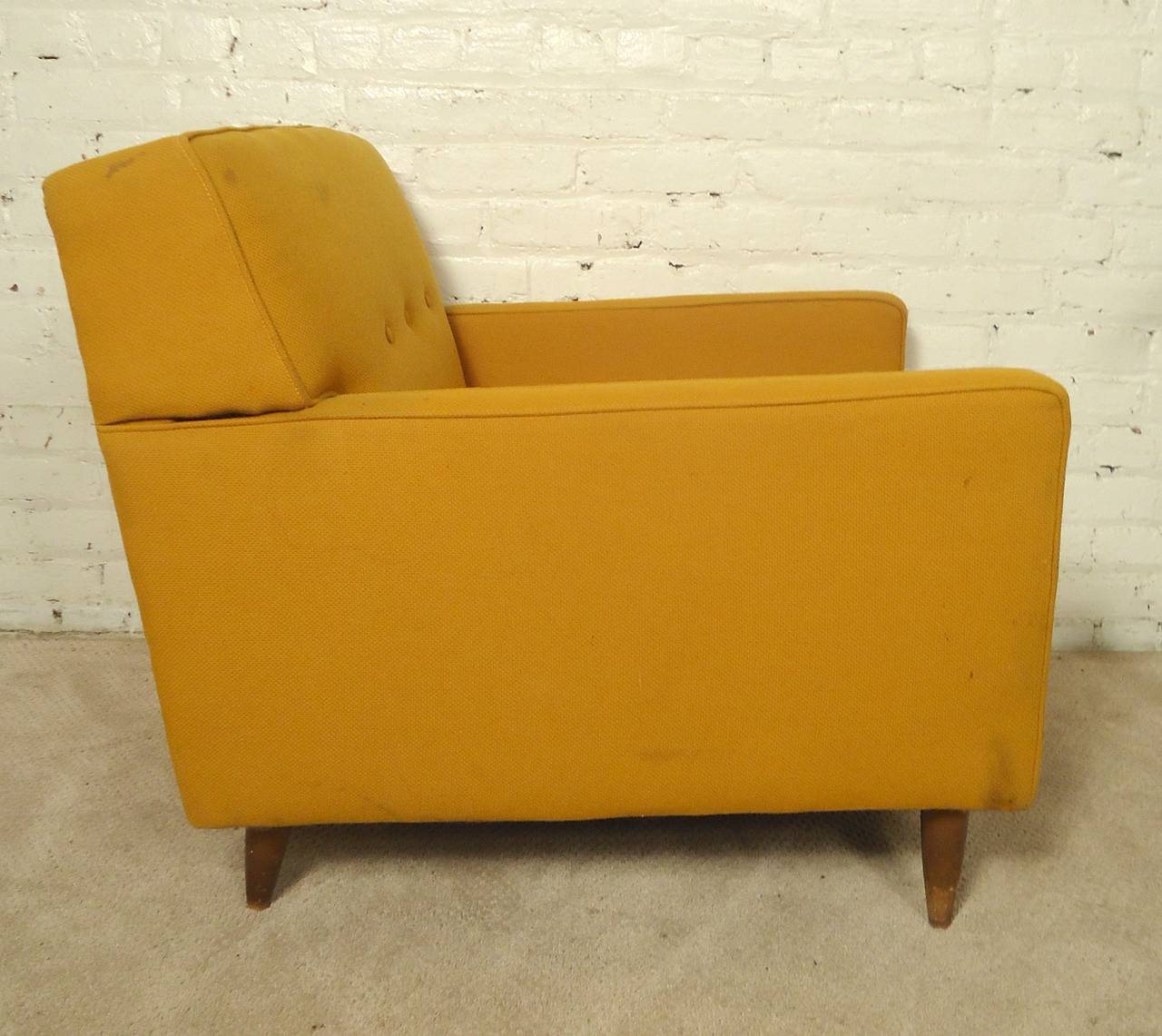 Well formed McCobb style armchair with tapered walnut legs. Deep seat, long arms and tufted back.

(Please confirm item location, NY or NJ, with dealer).