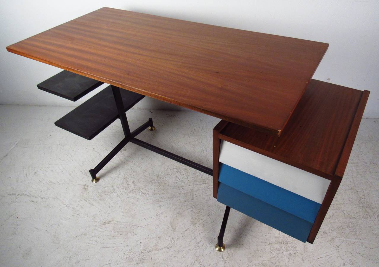 Stylish writing desk or workstation with three-drawer cabinet and open shelves in the manner of George Nelson. An extremely unique piece with a top that appears to be floating, a finished back, and painted drawer fronts. A sturdy metal base, walnut