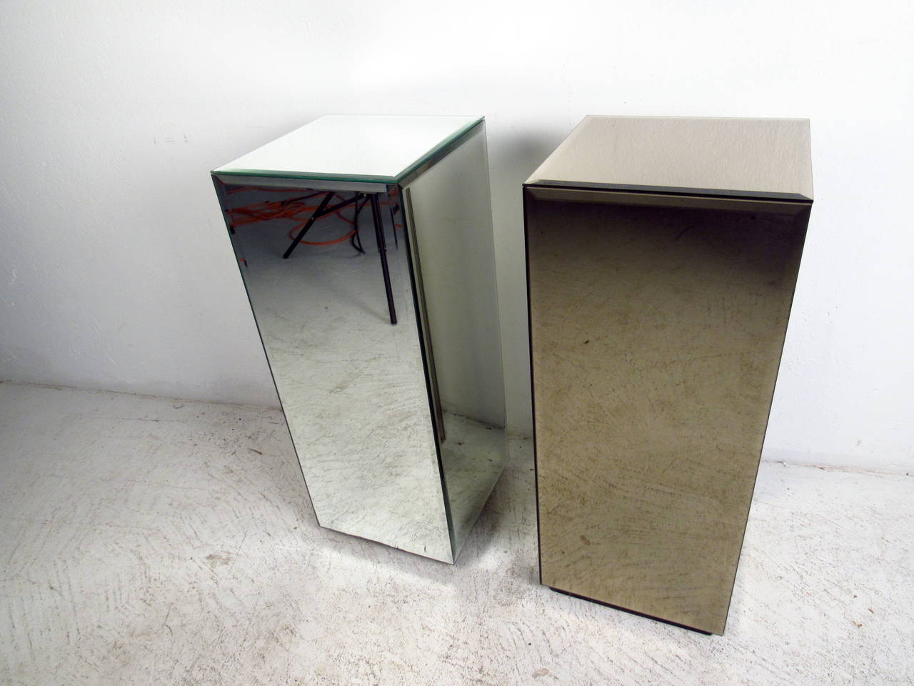 This pair of pedestals feature smoked glass while the other is a regular bevelled mirror which offer a contemporary accent to any home or office.

Please confirm item location (NY or NJ) with dealer.