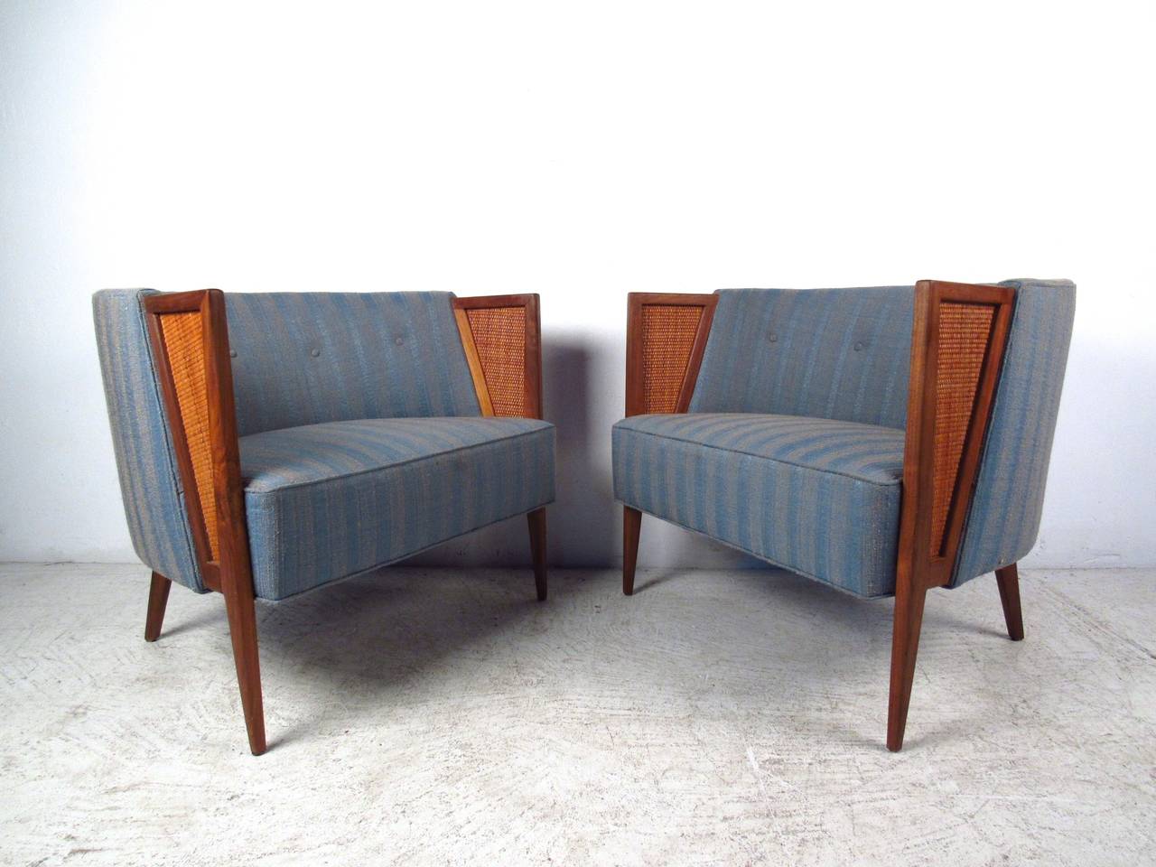 This exquisite pair of mid-century modern barrel back chairs feature unique design, perfect for any interior. Wonderful tapered legs, cane style seat back, and wide comfortable seats add to the midcentury charm of the pair. Great side chairs for