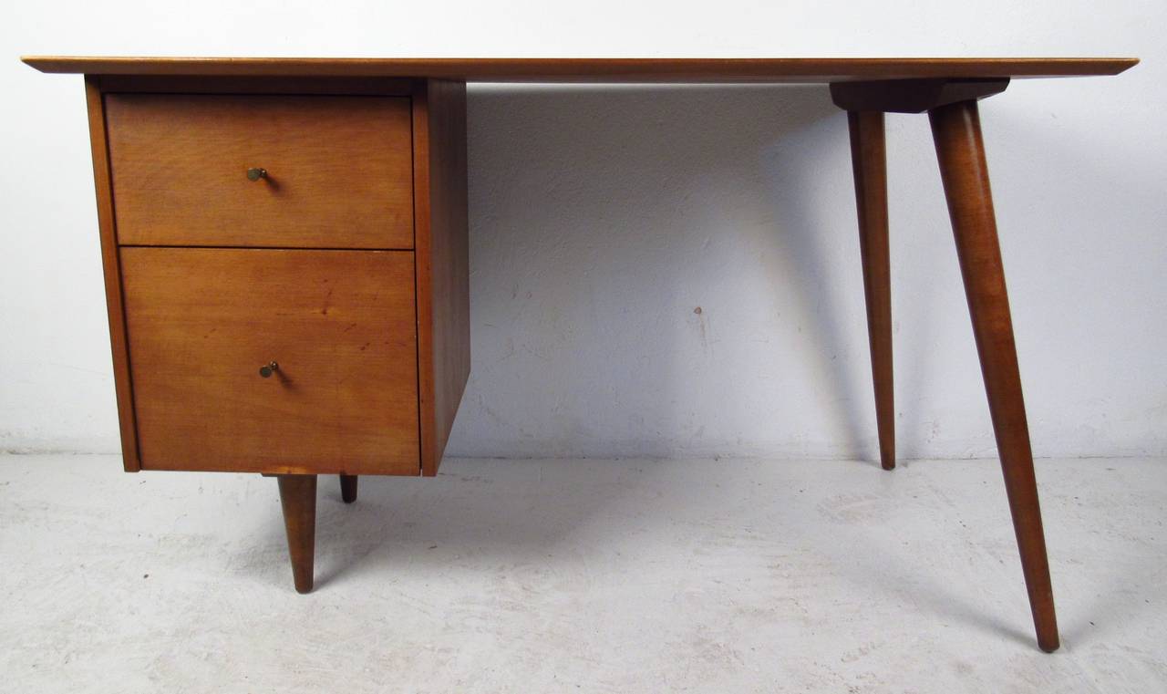 Classic Mid Century styling Planner Group series desk and matching chair in maple by Paul McCobb. Please confirm item location (NY or NJ) with dealer.