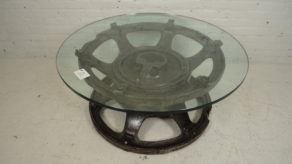 Industrial-look bare metal tractor wheel coffee table.