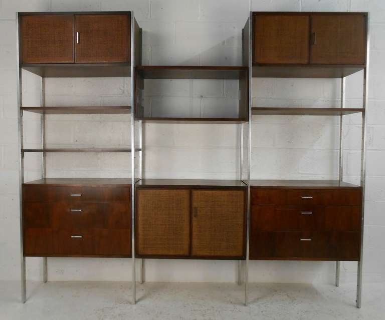 Mid-century freestanding modular wall unit in walnut by Founders. Please confirm item location (NY or NJ) with dealer.