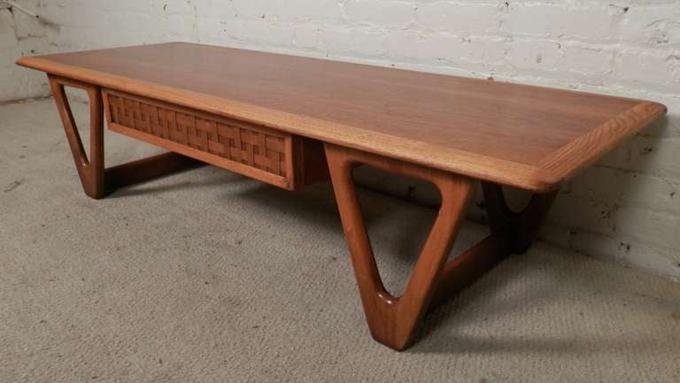 Lane brand coffee table with middle basket weave drawer. Shaped triangle form legs, oak and walnut grains and rounded edge top. Designed by Warren Church as part of the Perception Line for Lane.

(Please confirm item location - NY or NJ - with