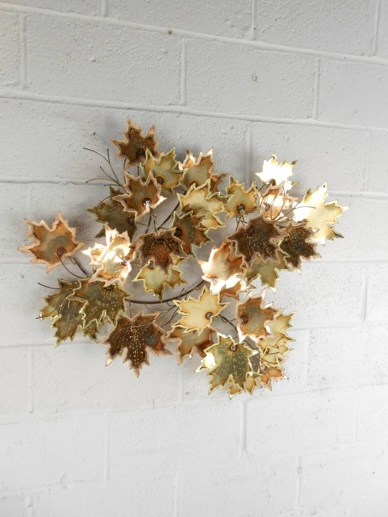 This unique brass wall sculpture features beautiful cut maple leaves and branches. The sculpture is signed 