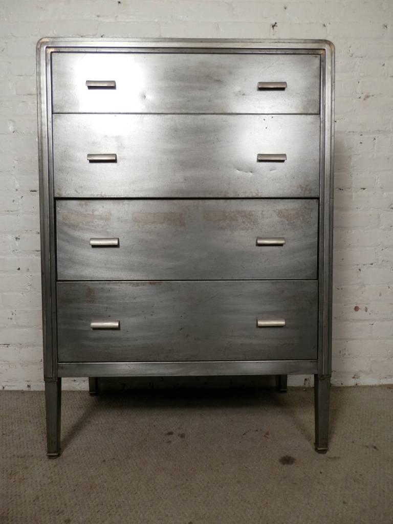 Handsome tall dresser by the Simmons Furniture Company. Made of strong metal, featuring curved edges and metal drawers pulls. The dresser has been restored in a sleek bare metal style.

(Please confirm item location - NY or NJ - with dealer)