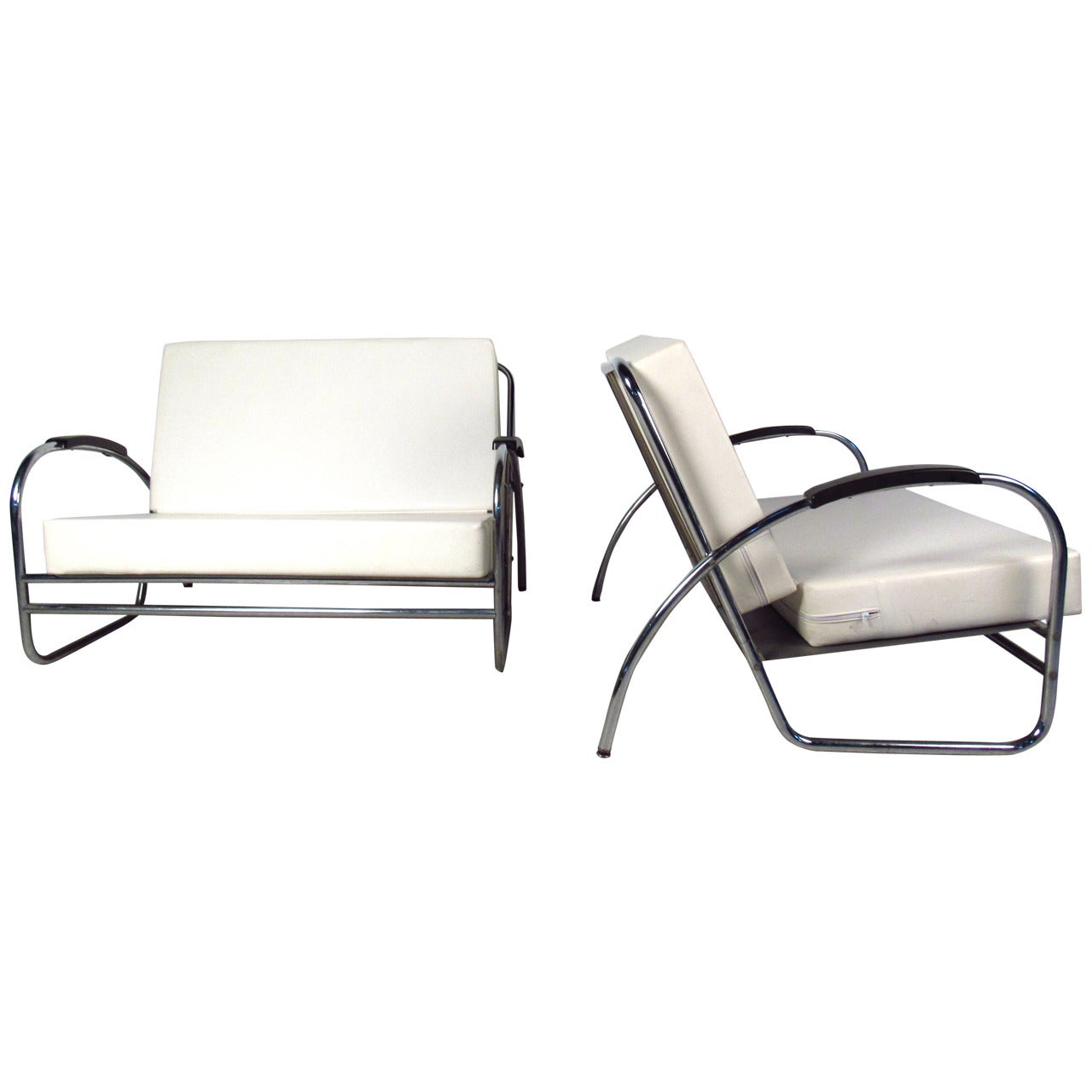 Great pair of tubular chrome love seats by Royal Metal feature quality mid-century modern construction. A sleek design with overstuffed removable cushions covered in white vinyl. The oversized  48