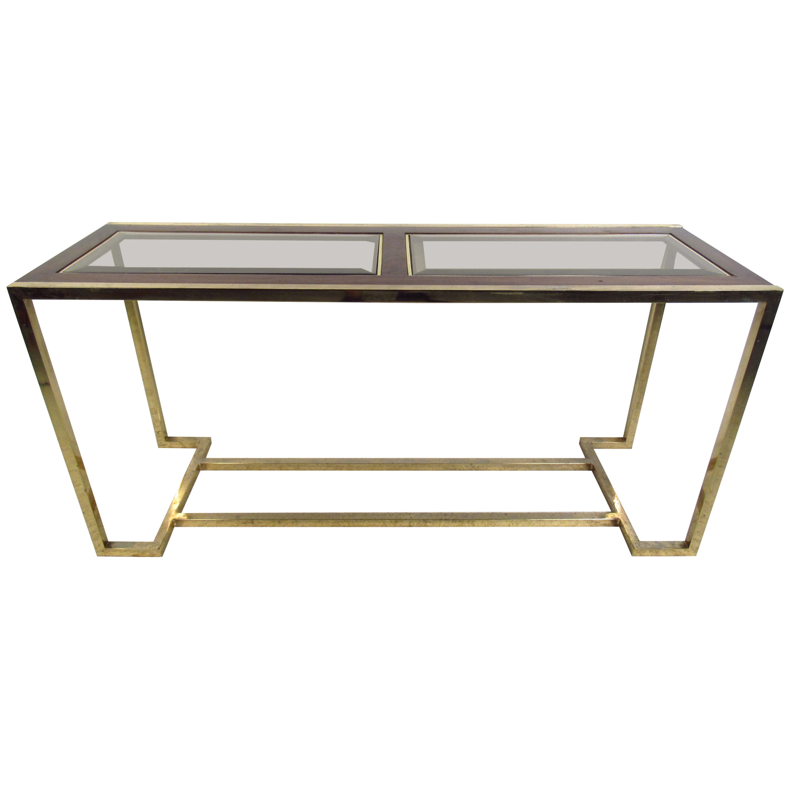 This midcentury console table features a walnut in lay with beveled glass atop a brass base which offers an elegant, modern flare to any home or office.

Please confirm item location (NY or NJ) with dealer.