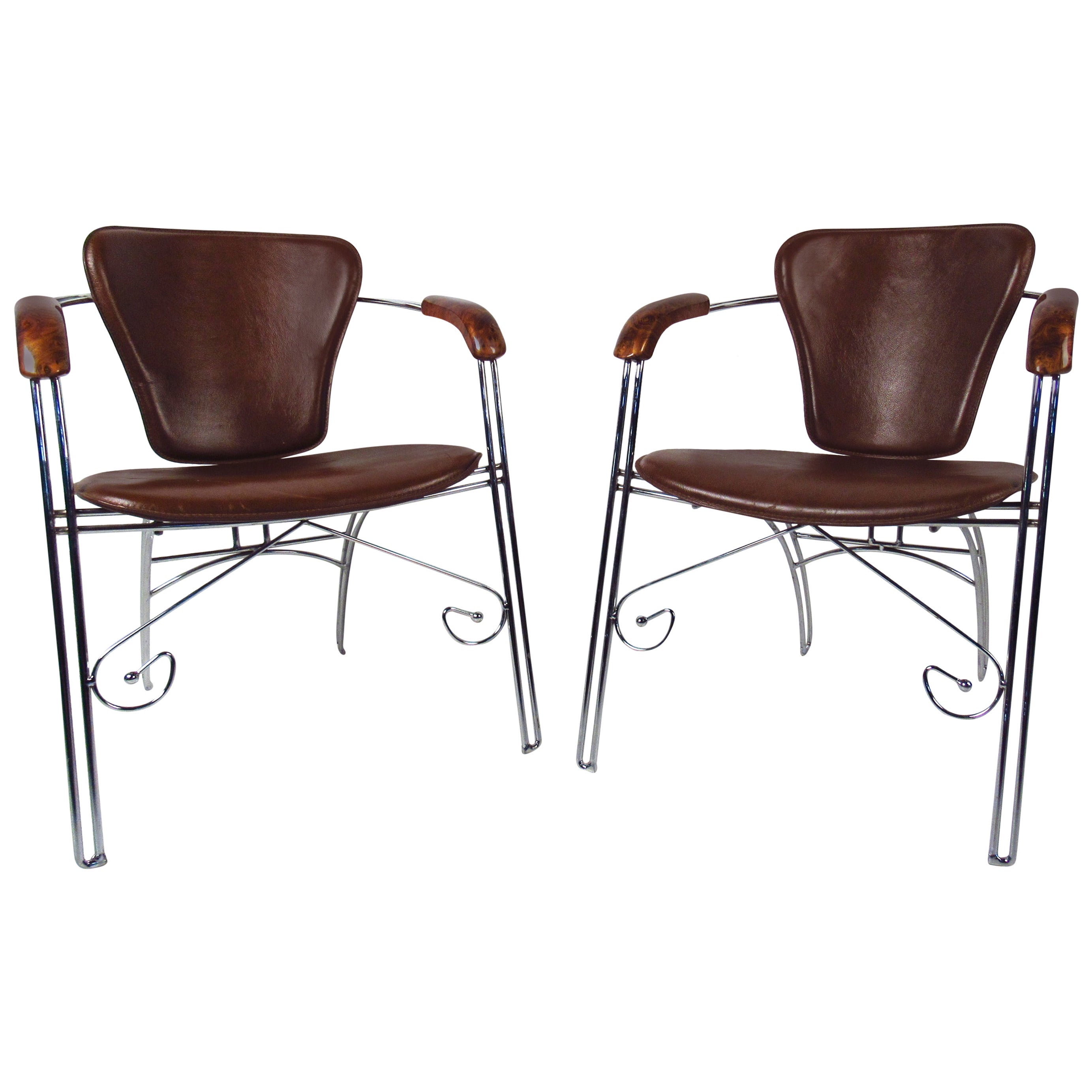 Unique pair of vintage leather armchairs feature sturdy decorative metal frames and make a striking addition to home or business seating arrangement. This pair of chairs offer rustic modern appeal without sacrificing comfort. Please confirm item