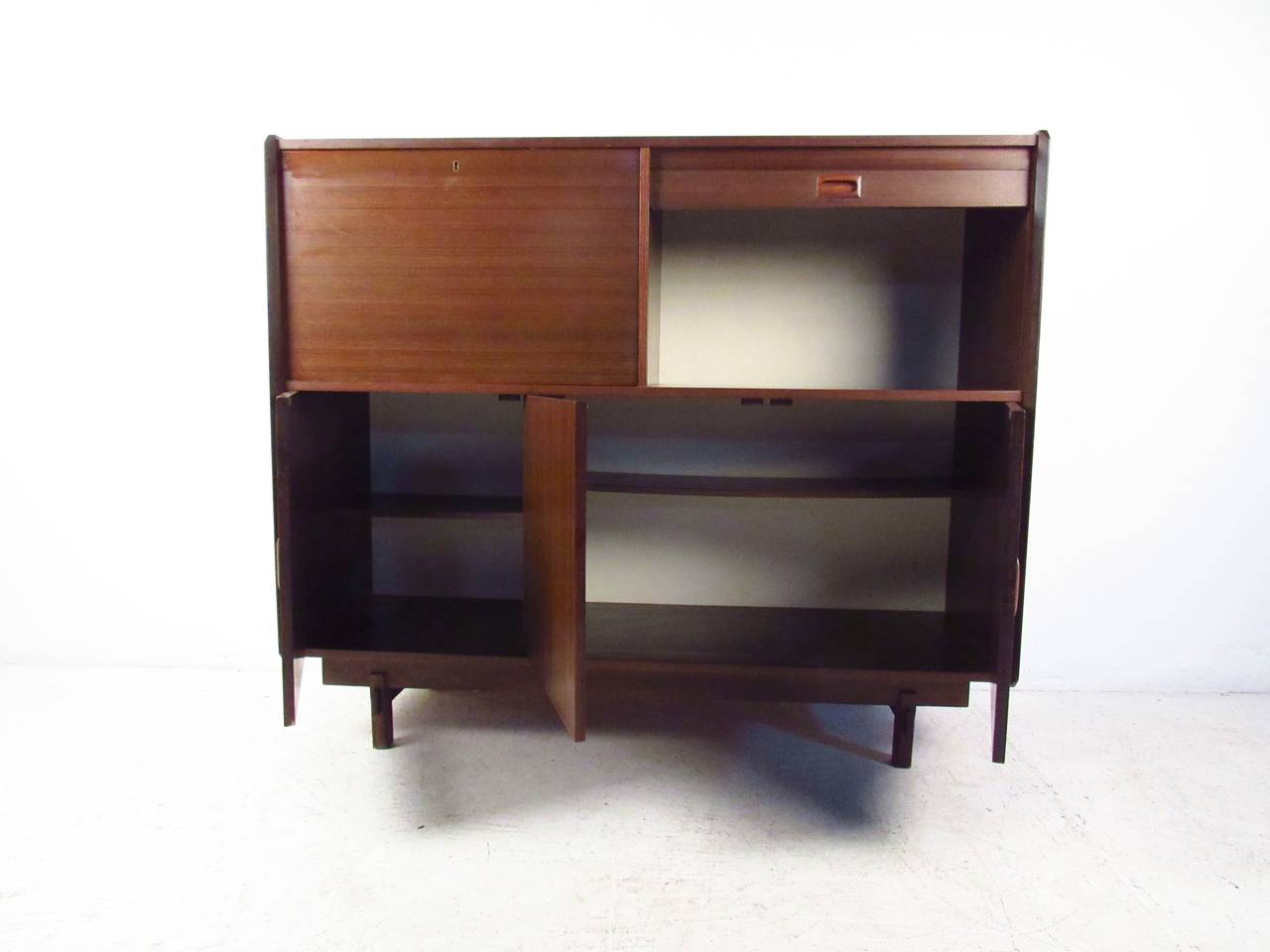 Mid-century modern Italian cabinet with four storage compartments. Rosewood grain throughout, sculpted handles, top right cabinet with tambour door. Very unusual design. Great for home or office storage.

(Please confirm item location - NY or NJ -