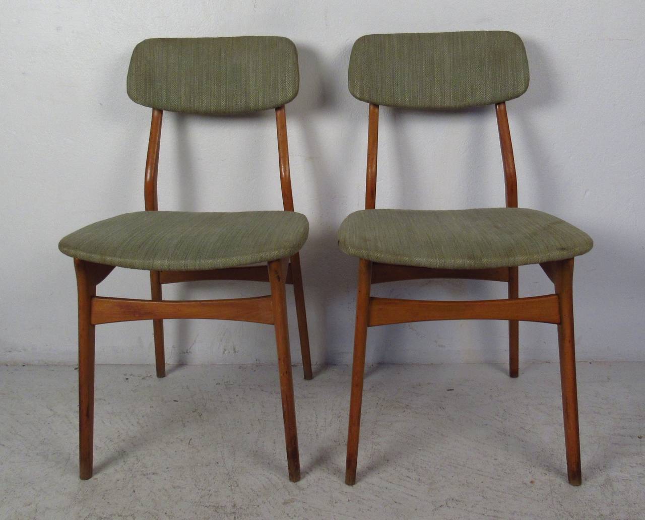 Six vintage modern dining chairs, each featuring upholstered seat and back with sculpted teak frames. A sleek design with floating style back rests, tapered legs, and curved stretchers for added sturdiness. 

Please confirm item location NY or NJ