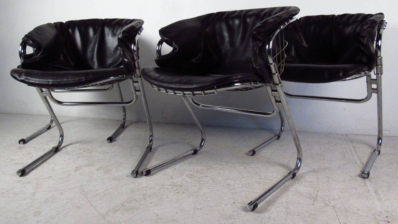Four vintage-modern uniquely shaped armchairs, features comfortably designed chrome rod frame and vinyl cushions. Cushions are removable.

Please confirm item location NY or NJ with dealer.