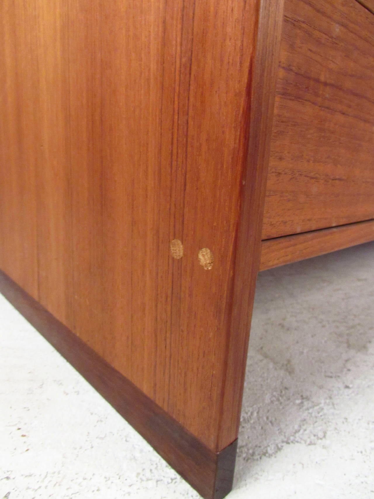Two vintage dressers made in Denmark, each featuring beautiful teak grain and sculpted pulls. Ideal matching set of drawers for bedroom storage, stunning midcentury Scandinavian design. 

Please confirm item location NY or NJ with dealer.