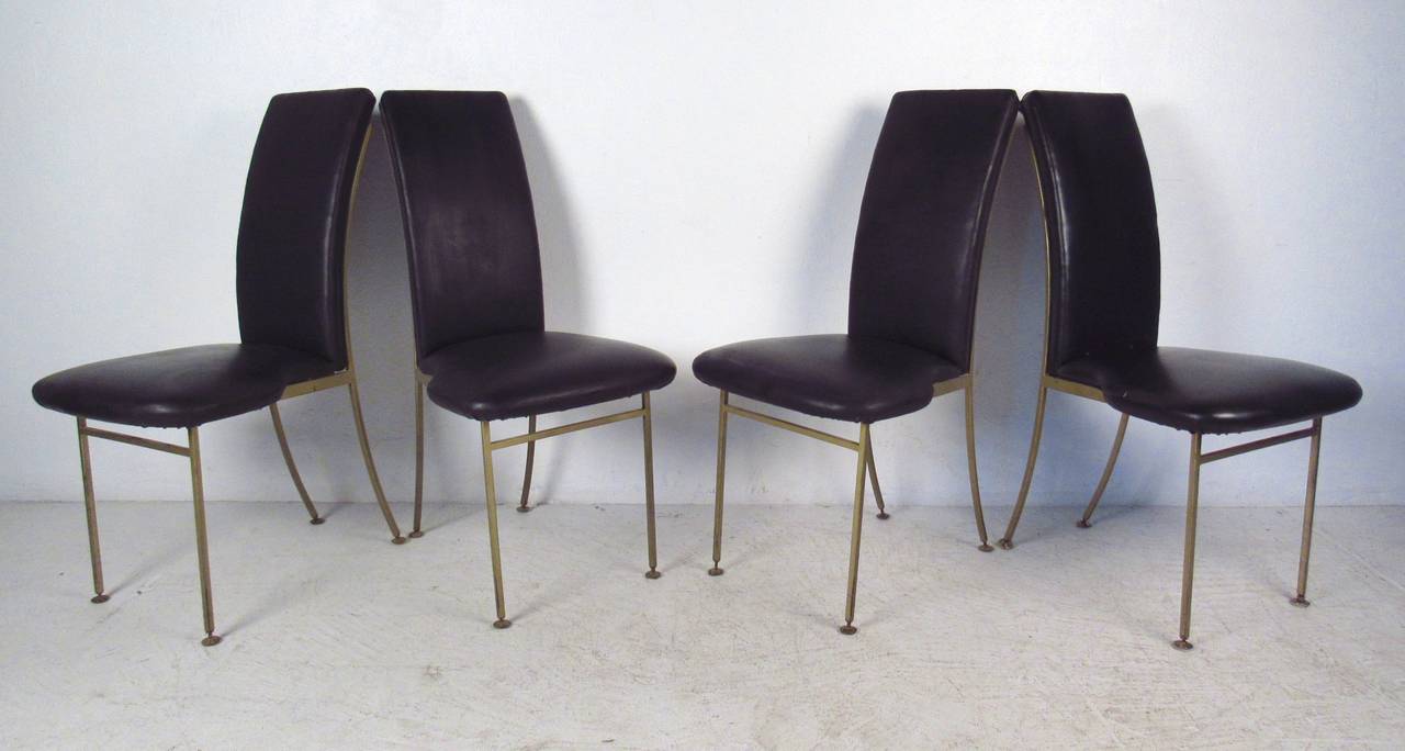 Sleek dining chairs in black vinyl with brass frames. Attractive curved back, simple modern design.

(Please confirm item location - NY or NJ - with dealer).